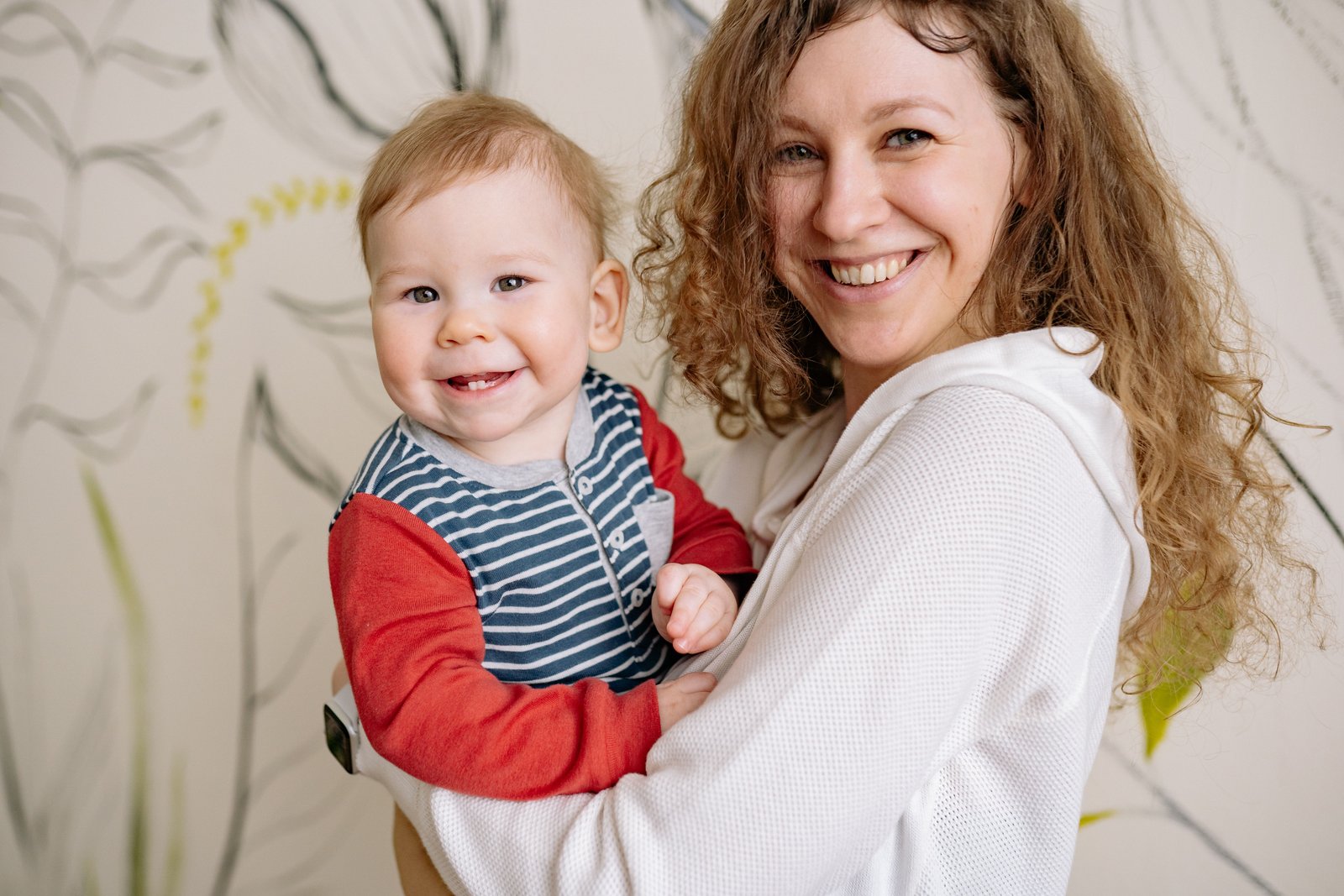 Mother laughing with her toddler at home